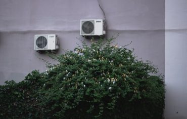 two air conditioners next to wall